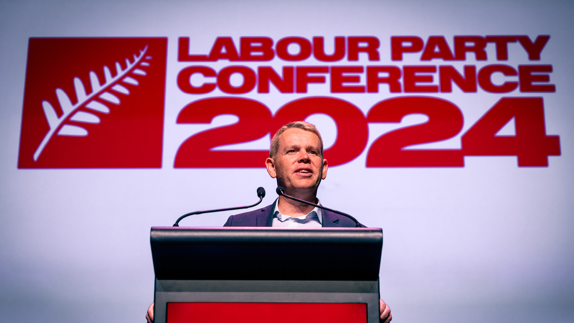 The 2024 New Zealand Labour Party Conference with Chris Hipkins in front of the logo I designed for the event.