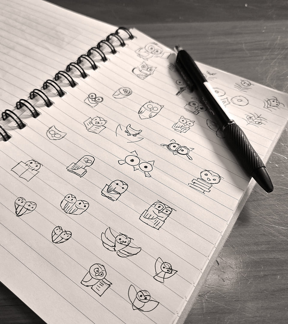 Stuart Tax Group Inc owl logo sketches on a notepad